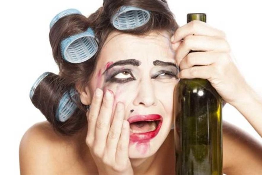 Girl looking stressed with wine bottle