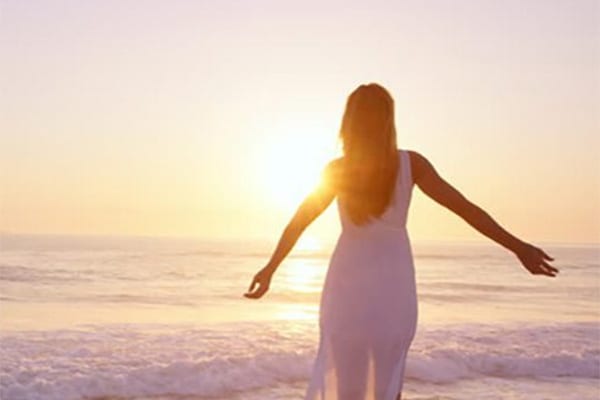 Girl on beach relaxed at sunset