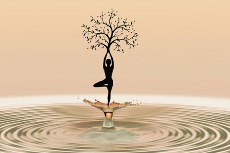 Woman standing in puddle with tree of life